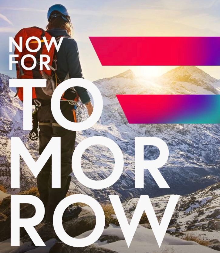 Wanderer steht am Berg und sieht hinunter. Bunte Digital Austria Fahne. Text: Now for tomorrow © Accenture - Accenture