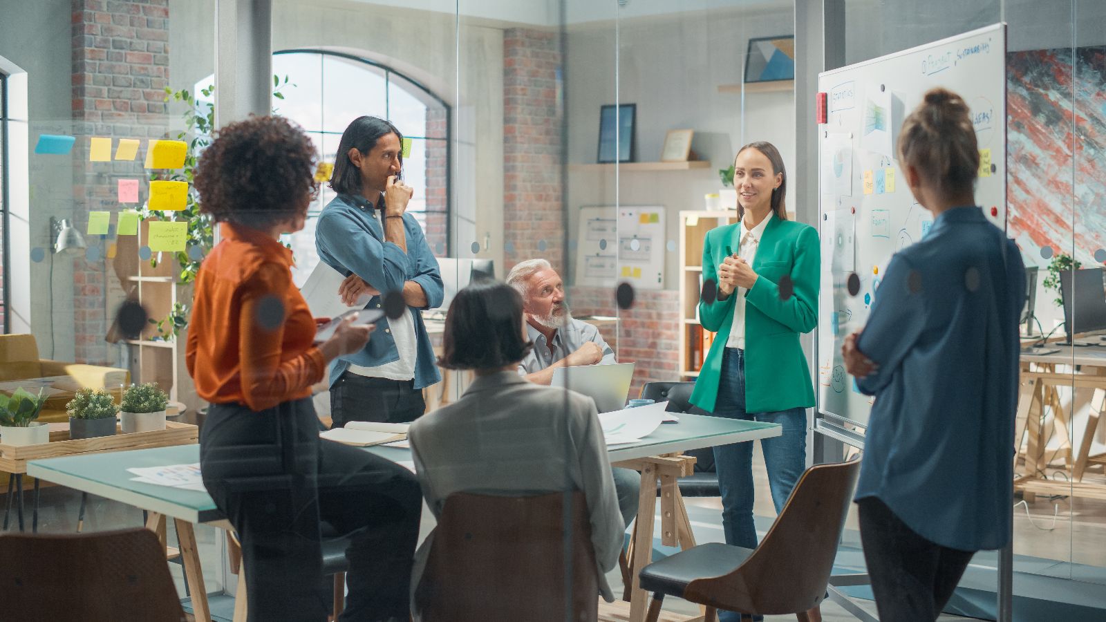 Trainerin schreibt auf Whiteboard und schult interaktive Mitarbeiter &copy; Gorodenkoff  - Adobe Stock 