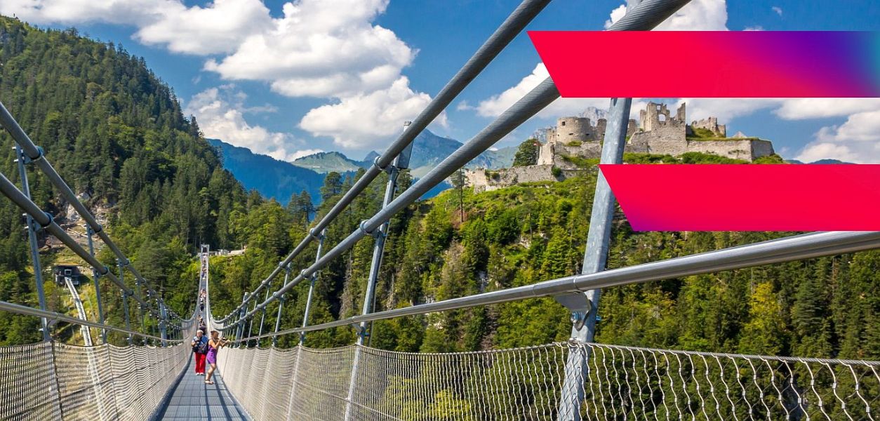 people cross a suspension bridge, Digital Austria logo is in the front